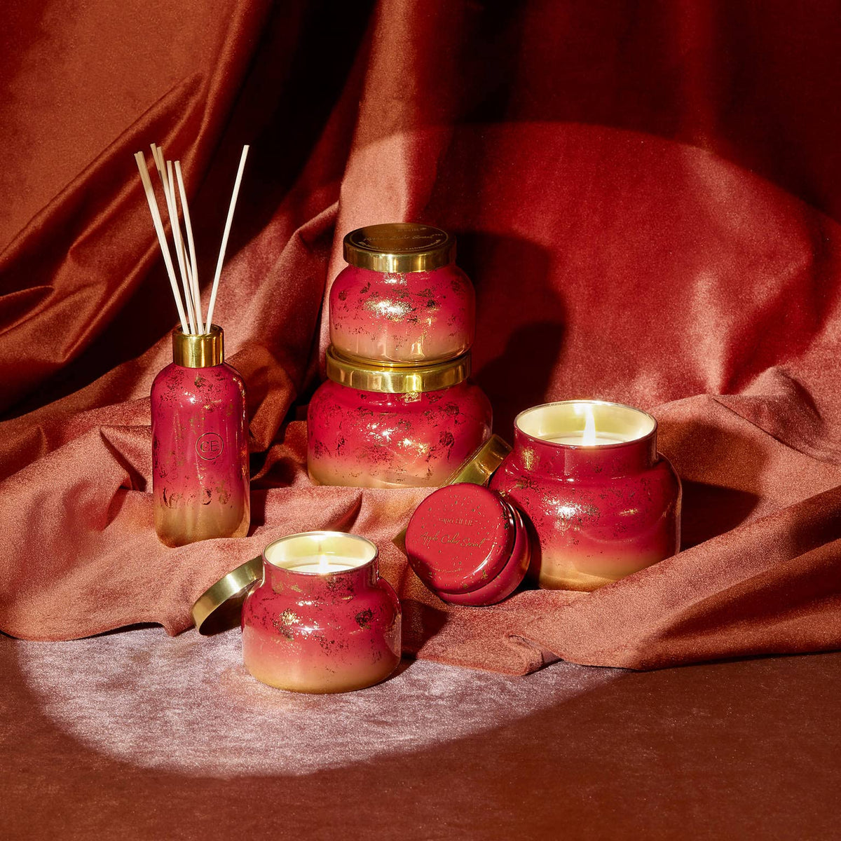 Capri Blue Glimmer Mini Tin - Apple Scented Candle with Mini Candle Holder - Soy Wax Blend - Capri Blue Apple Cider Social Red and Gold (3 oz)